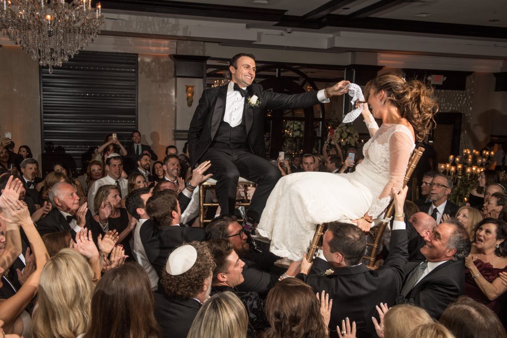 Bride and Groom lifted up in chairs