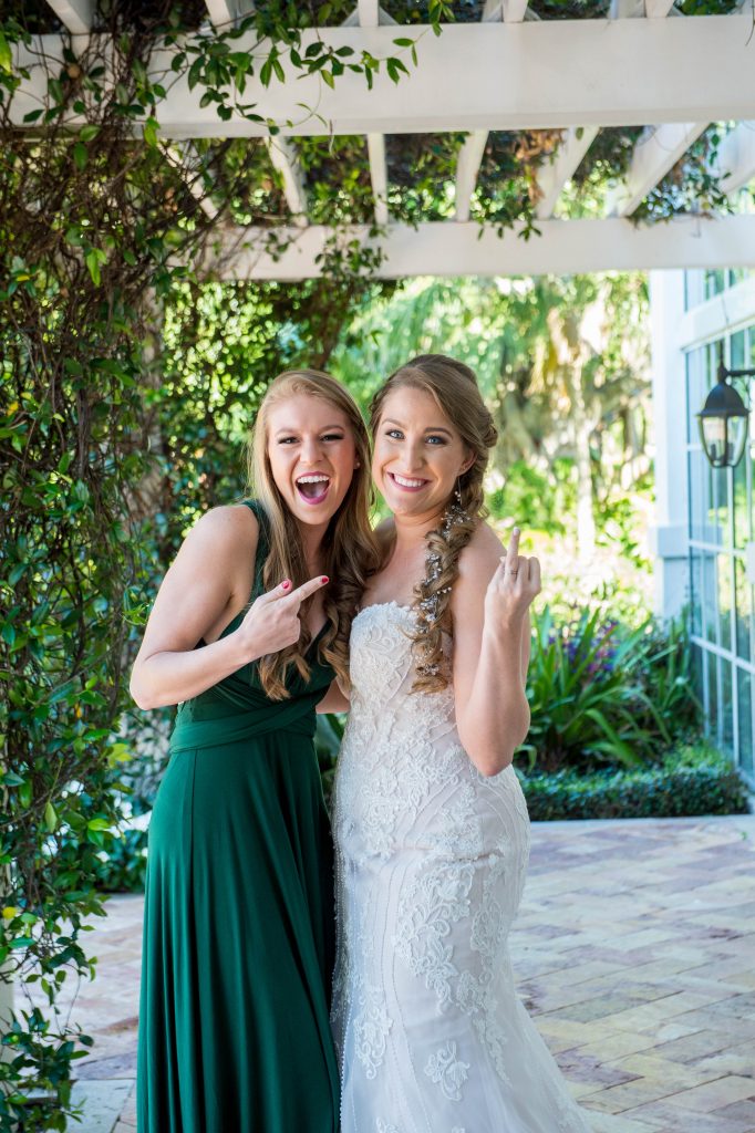 bride with bridesmaid showing her ring