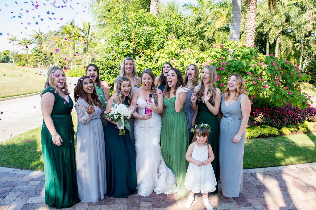 bride popping confetti with bridesmaids