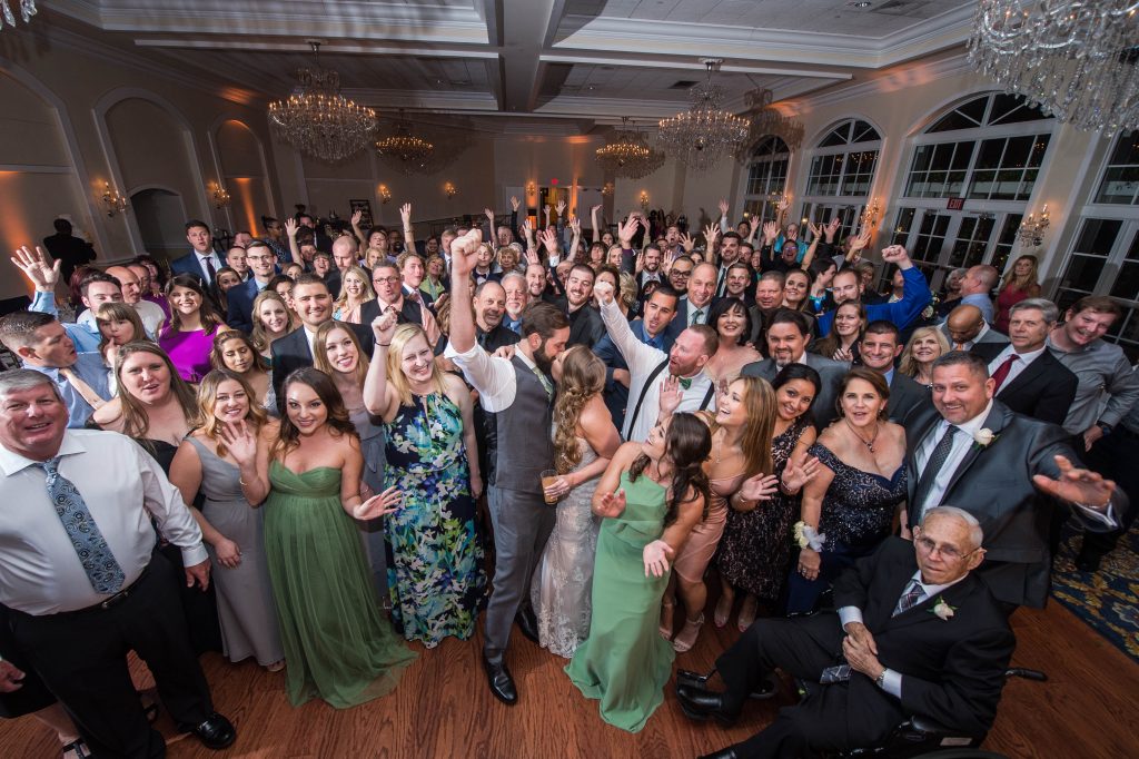 bride and groom with all family on dance floor