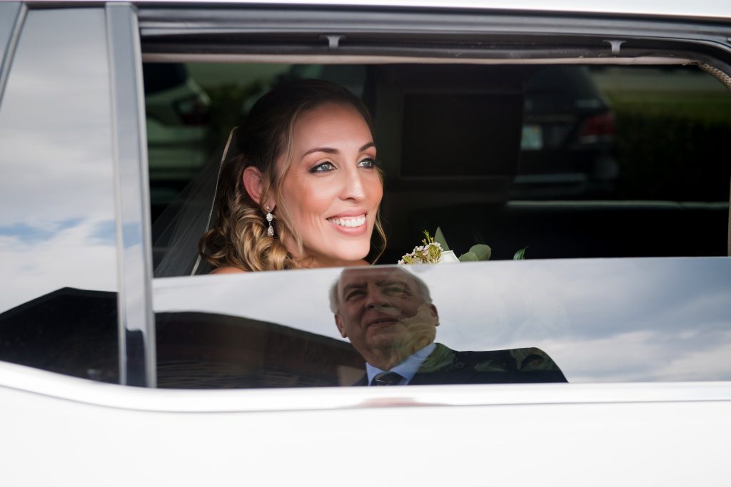 bride looking out limo at her father