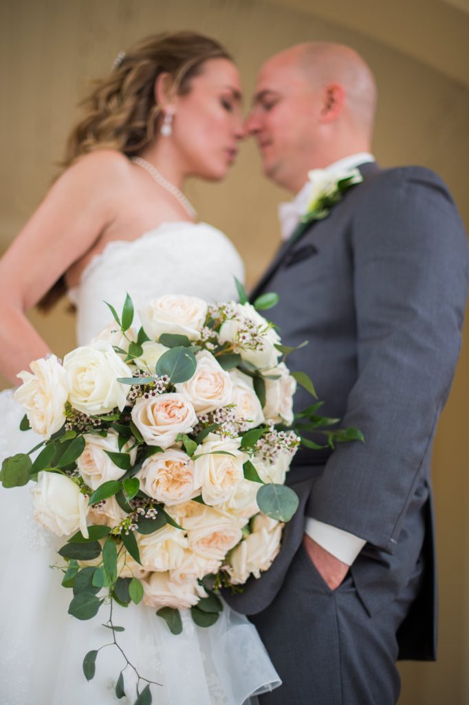 wedding bouquet with bride and groom