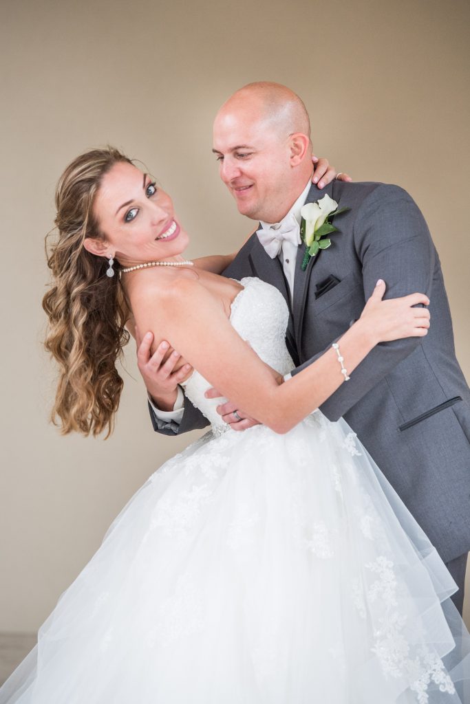 groom smiling at bride