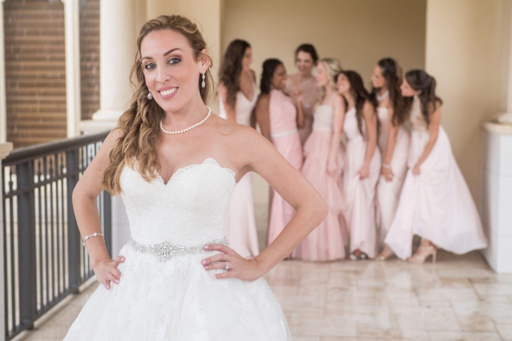 Bride with her bridesmaids behind her