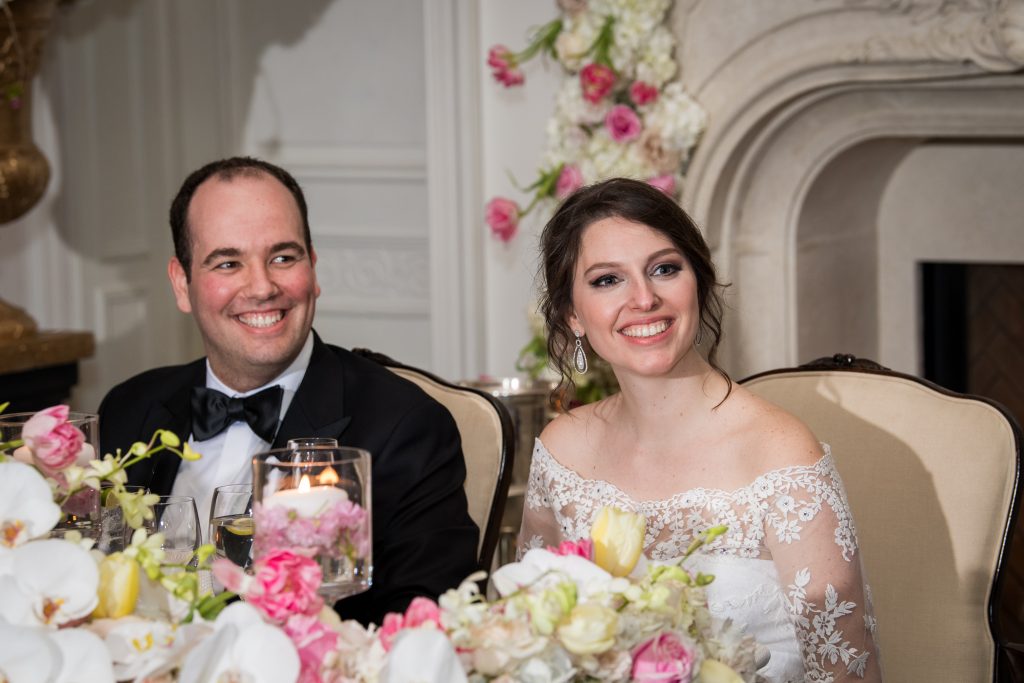 bride and groom laugh during speeches