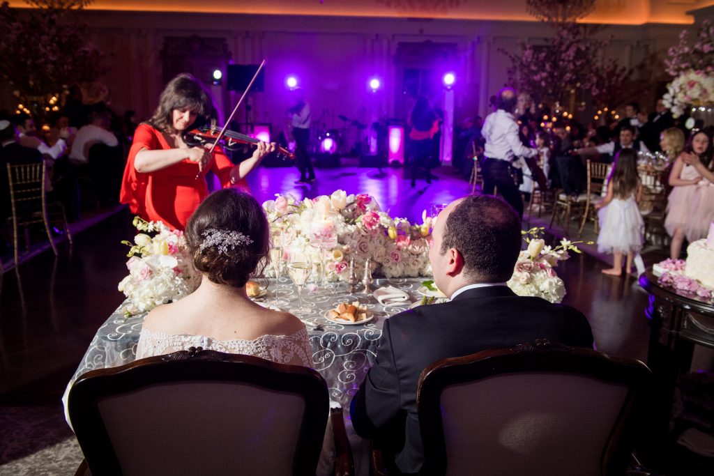 violinist plays to bride and groom