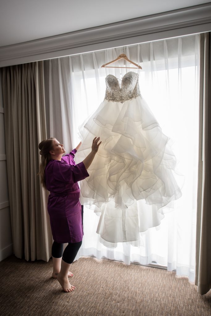 bride looking at her wedding dress