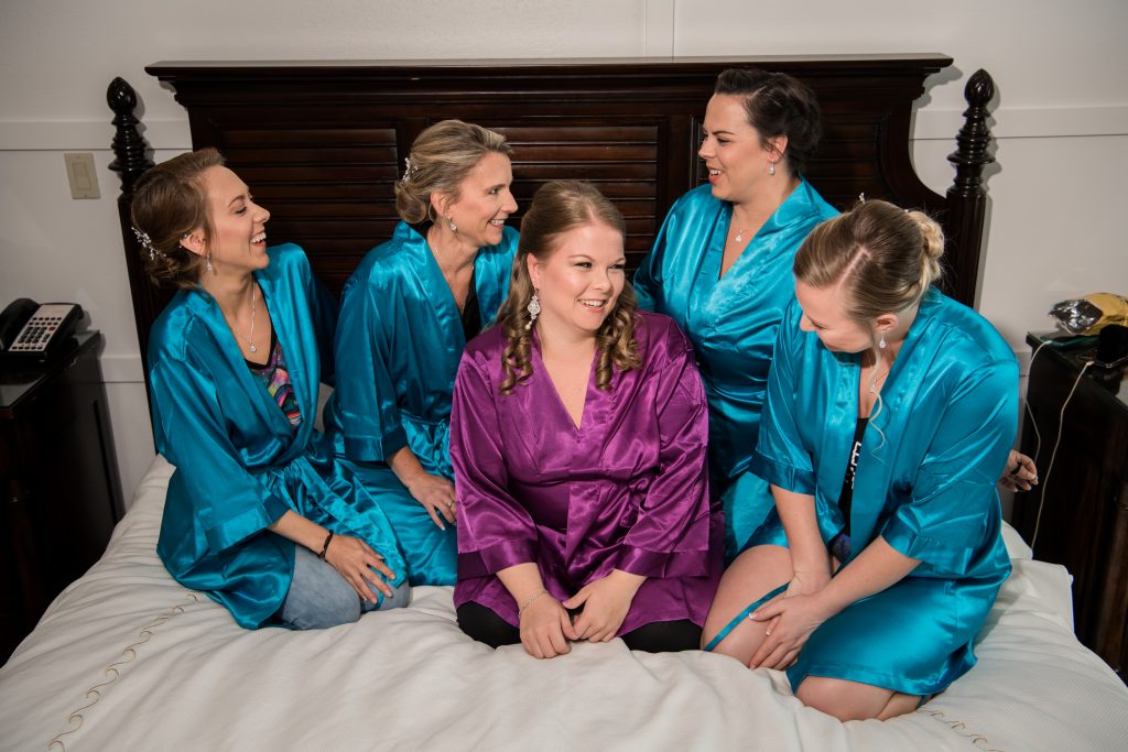 bride with her bridesmaids getting ready