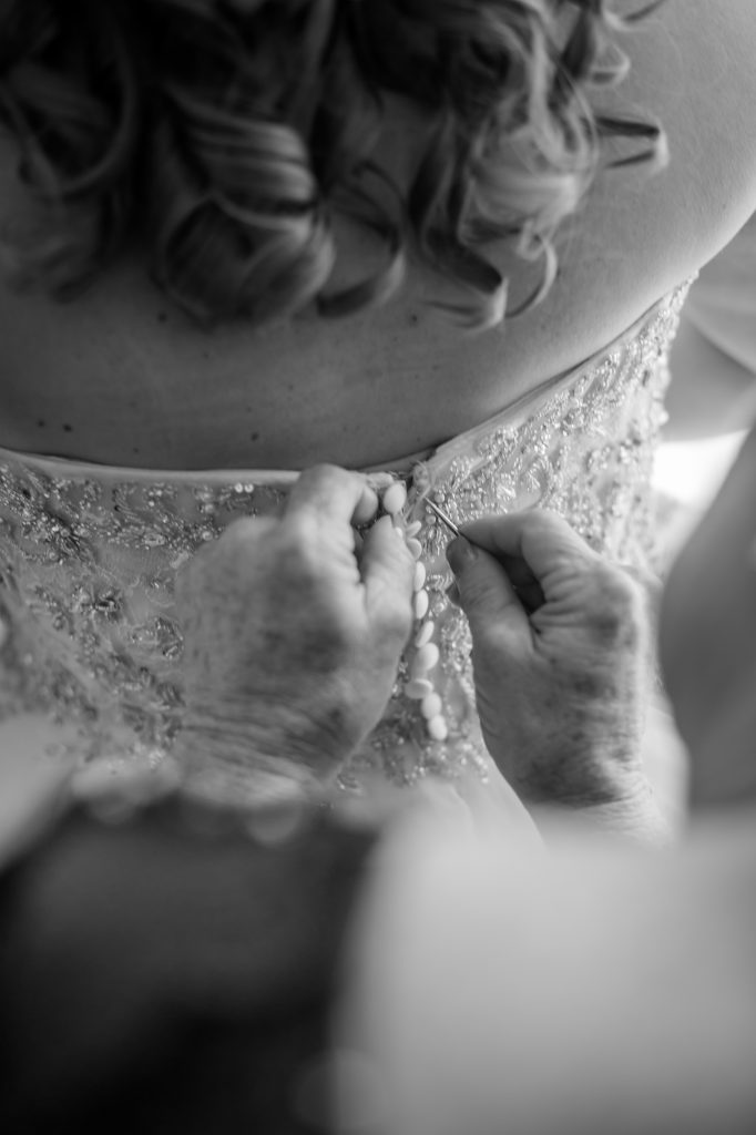 bride putting her dress on