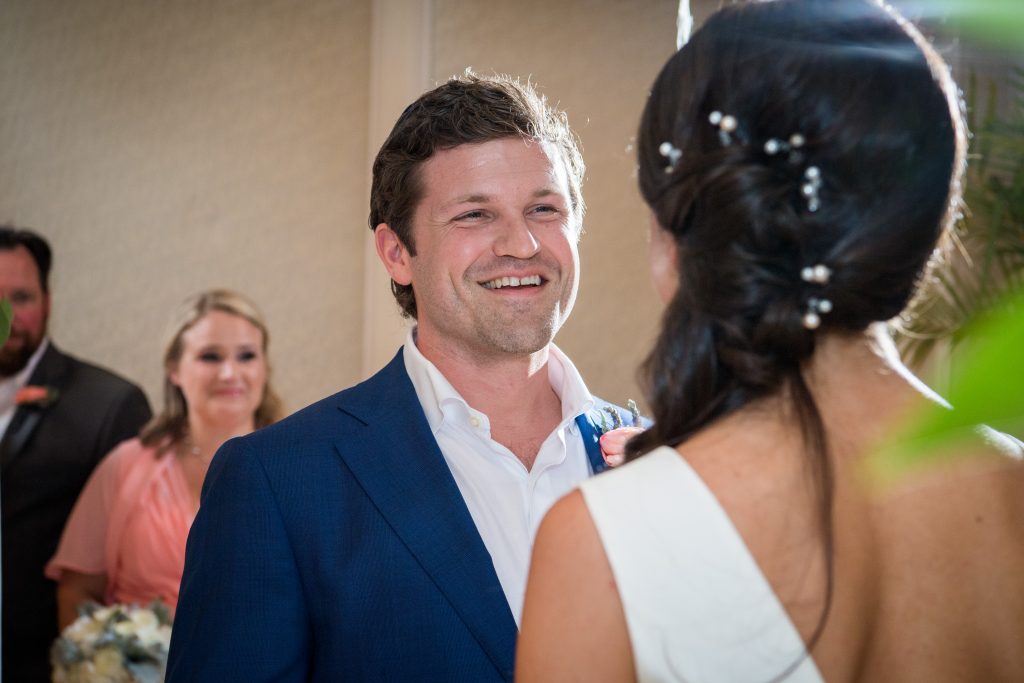 groom smiles during ceremony