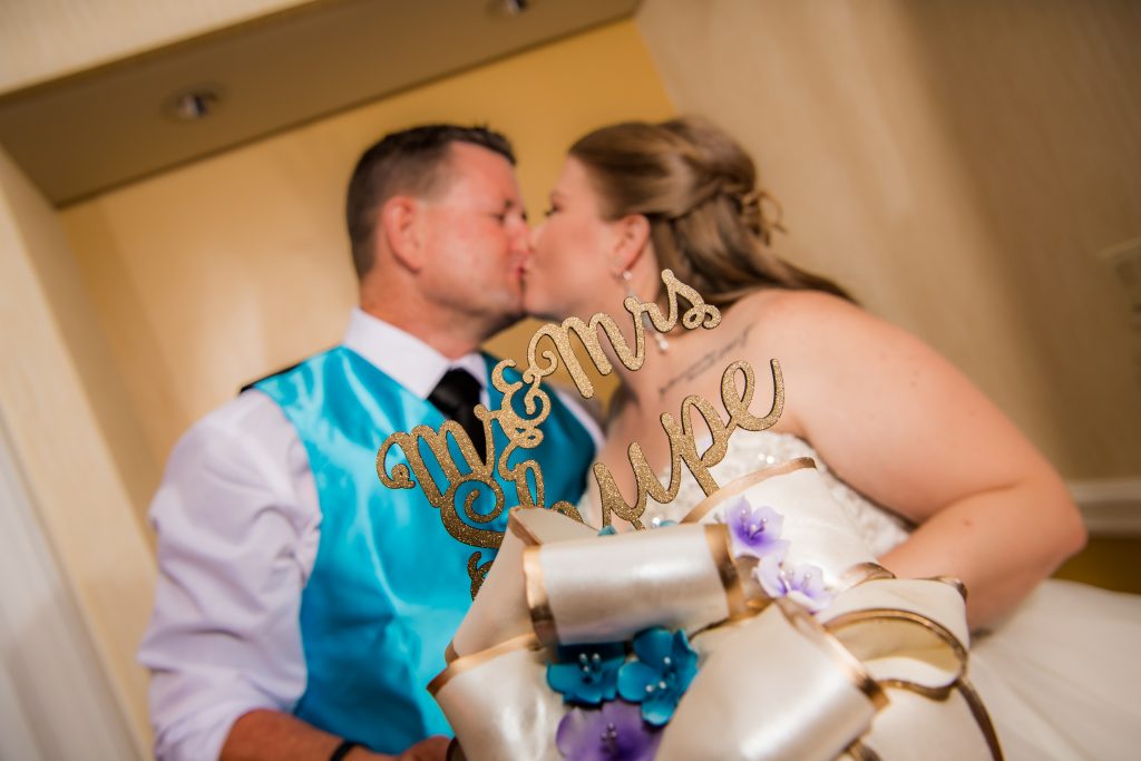 bride and groom cake kiss