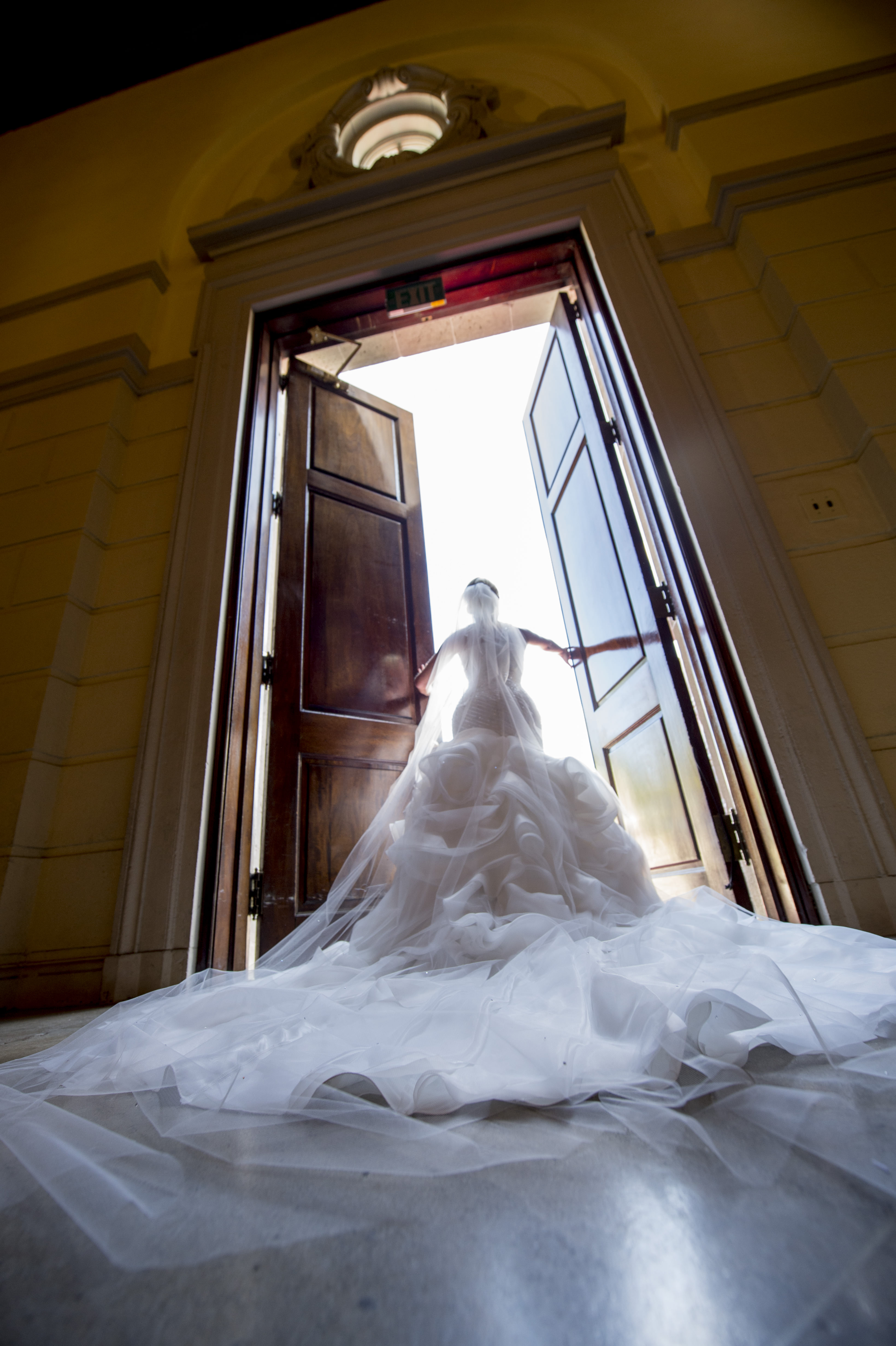 Bride in gown opening door
