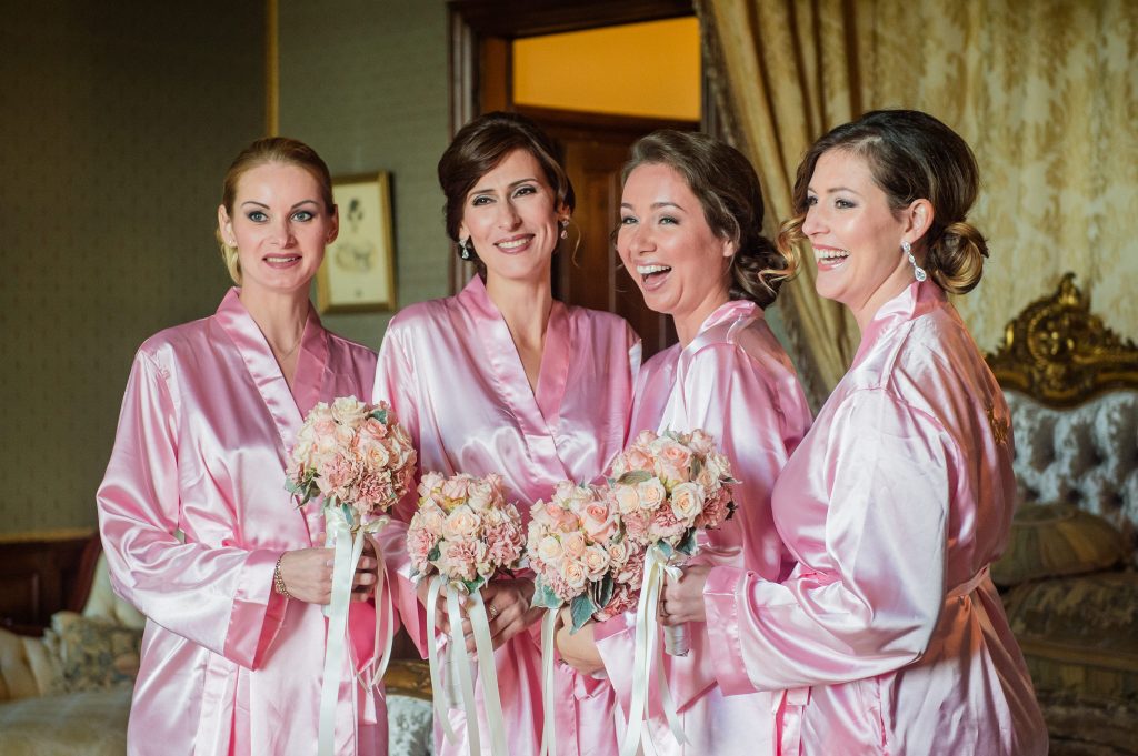 Bridesmaids smiling in gowns