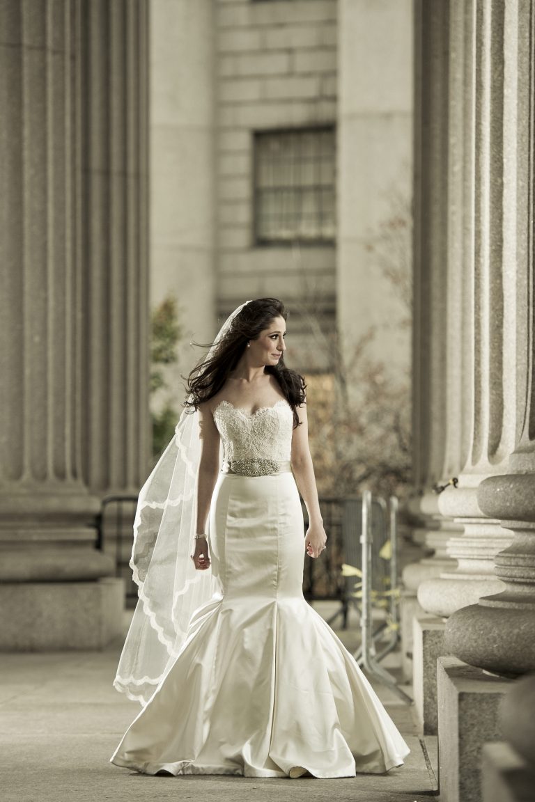 Bride walking against pillar