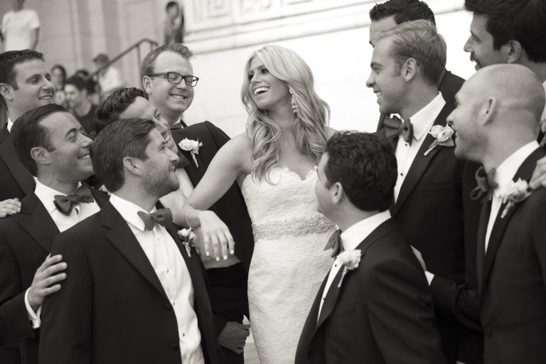 Bride laughing with groomsmen