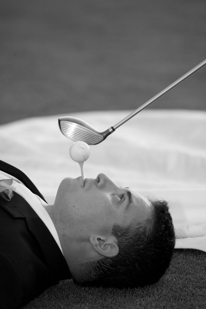 Groom with golf ball on mouth