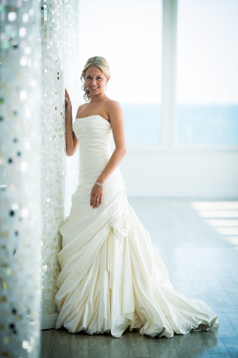 Bride standing against mosaic wall