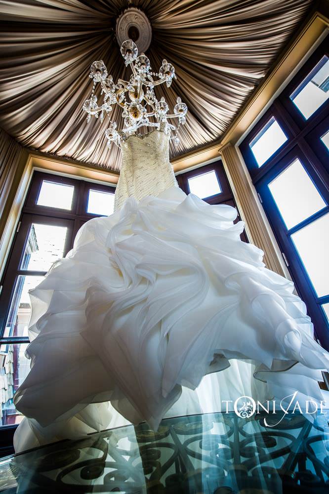 Wedding gown hanging from chandelier