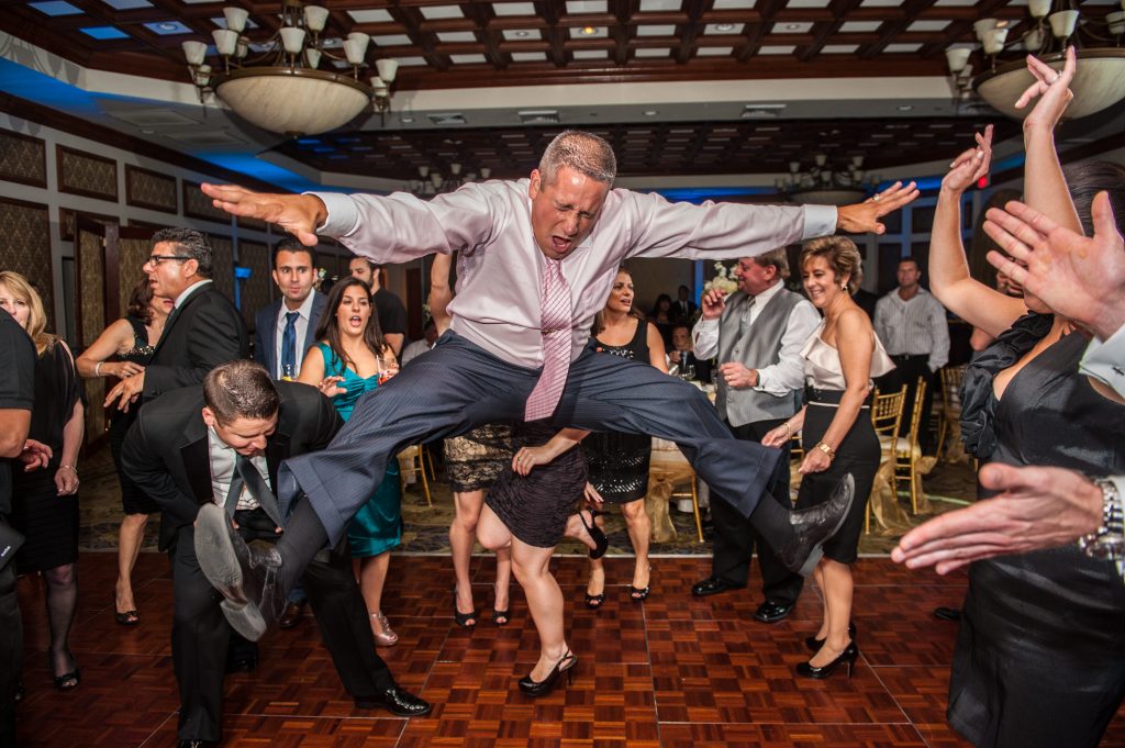 Wedding guest jumping in air