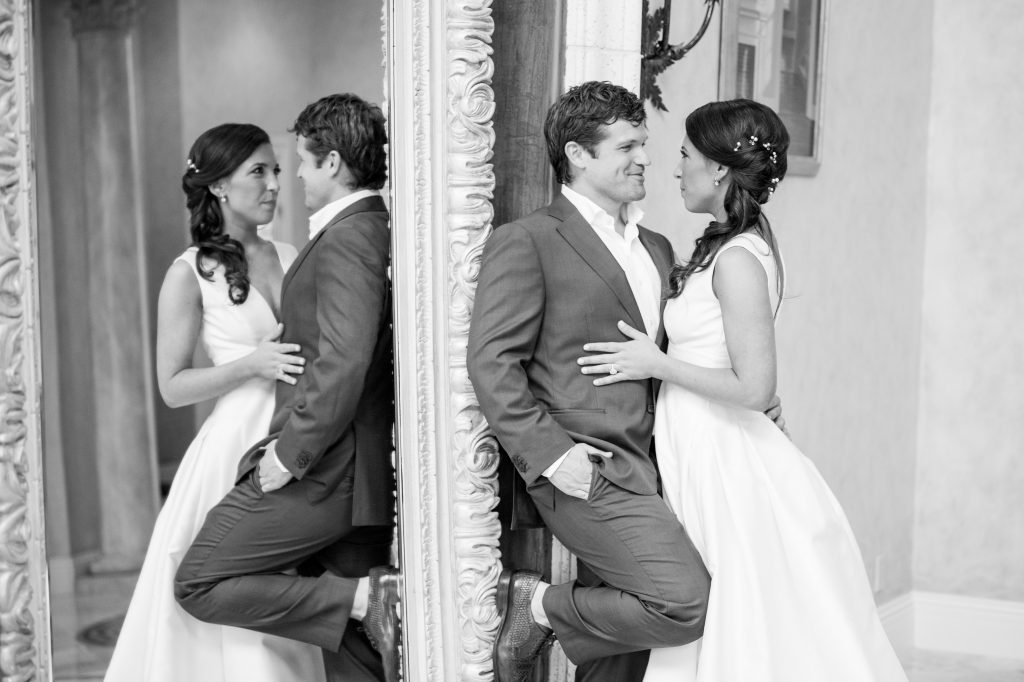 Bride and grooming in mirror looking at each other
