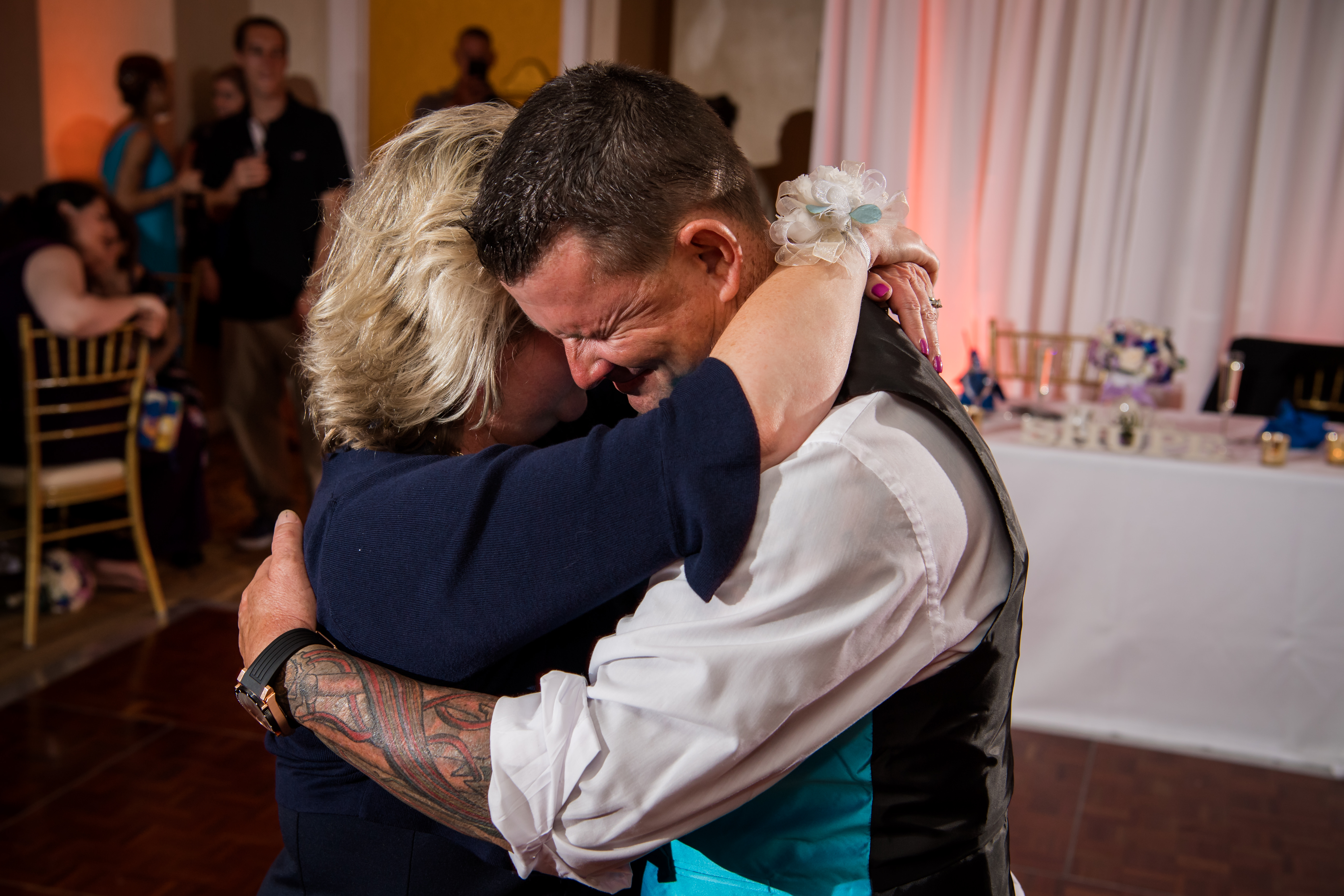Tattoo groom crying with his mom