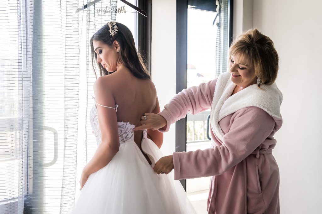 Brides mom helping close the dress